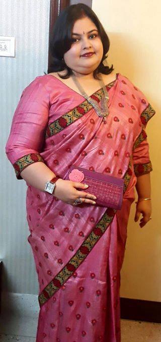 Dyed Tussar with Cross Stitch Embroidery pink from Sanskriti by Lalia Duttagupta. Accessories include a matching clutch and a simple necklace. 